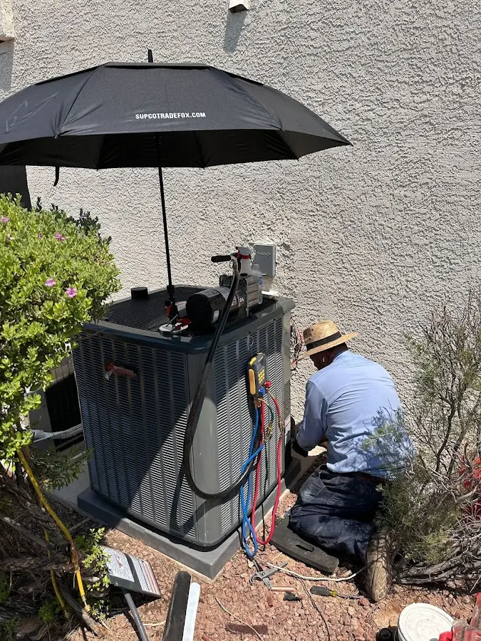 HVAC technician performing outdoor AC maintenance in Saginaw